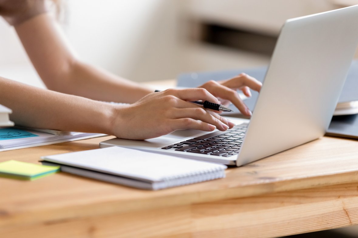 Closeup cropped image student girl hands typing using laptop Closeup cropped image student girl hands typing using laptop