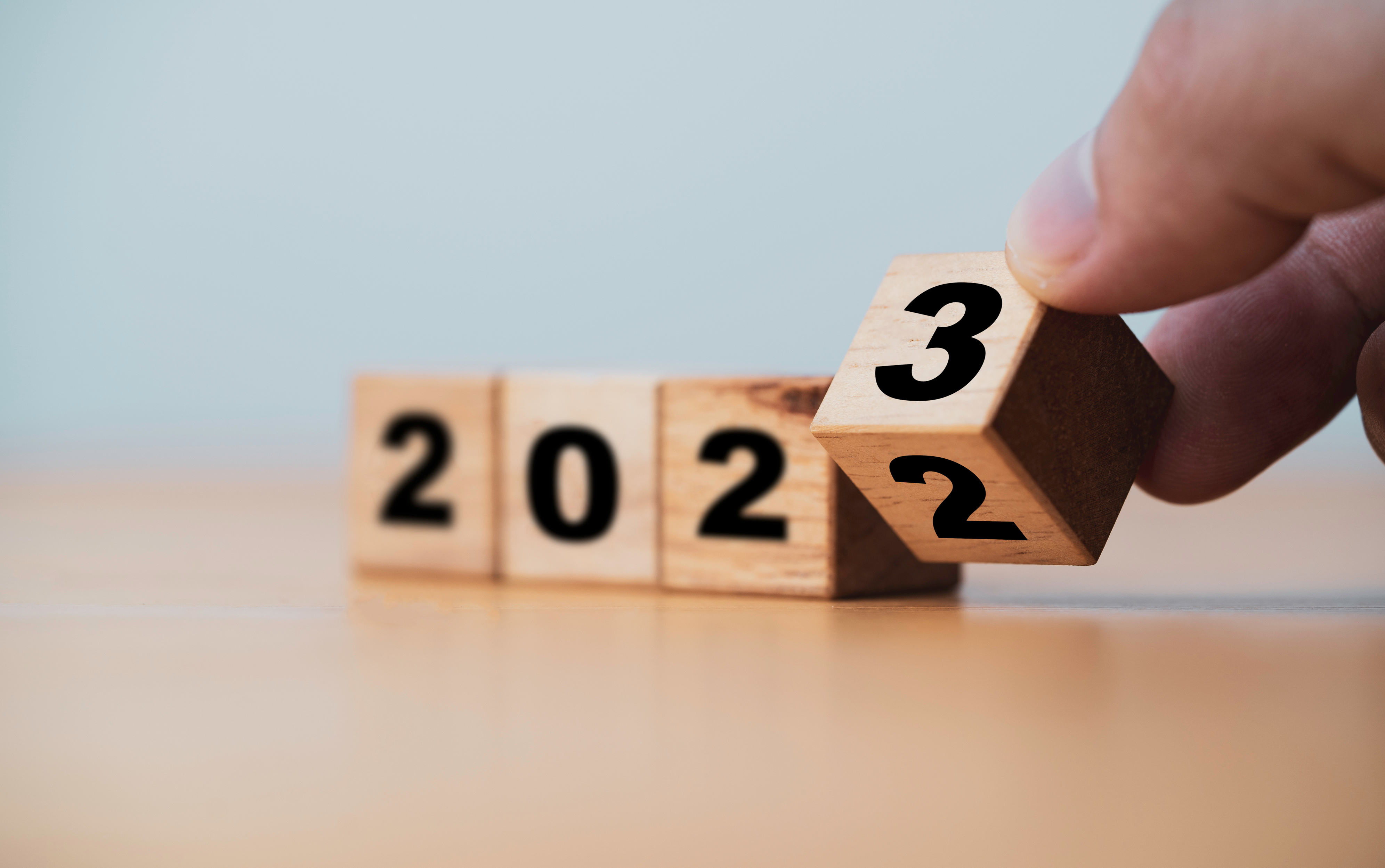 Wooden block cube flipping between 2022 to 2023 for change and preparation merry Christmas and happy new year. Wooden block cube flipping between 2022 to 2023 for change and preparation merry Christmas and happy new year.