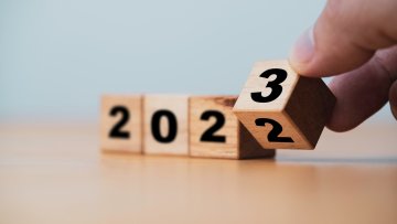 Wooden block cube flipping between 2022 to 2023 for change and preparation merry Christmas and happy new year.
