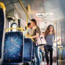 Curly girl is passing through the bus and trying to find a free seat. Curly girl is passing through the bus and trying to find a free seat.
