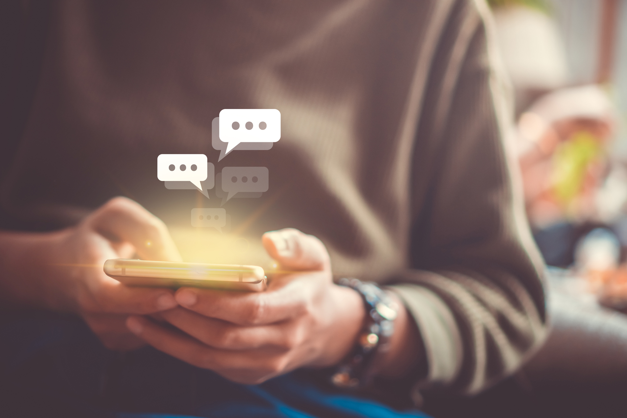 Women hand using smartphone typing, chatting conversation in chat box icons pop up. Social media maketing technology concept.Vintage soft color tone background. Women hand using smartphone typing, chatting conversation in chat box icons pop up. Social media maketing technology concept.Vintage soft color tone background.