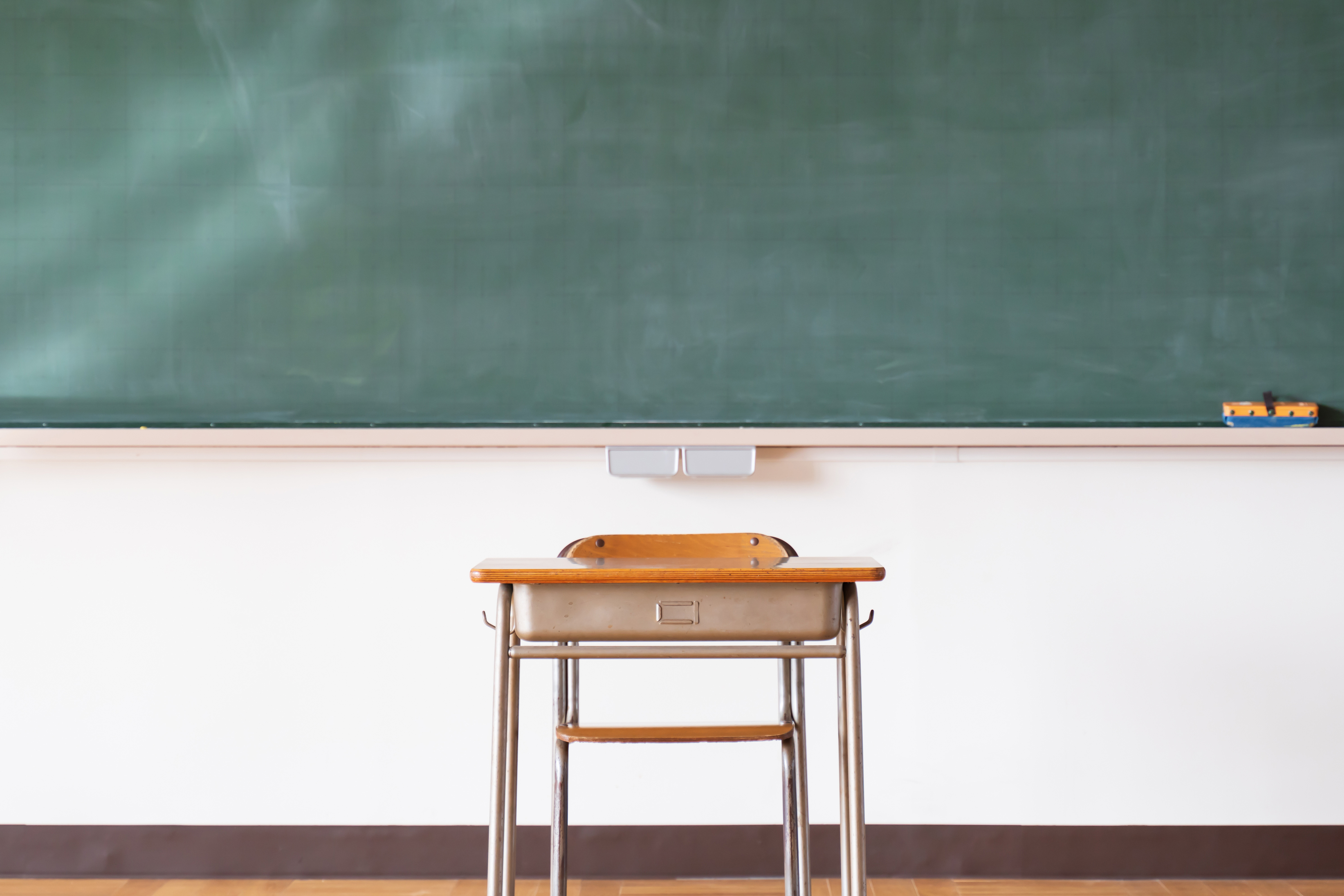 An image of a Japanese elementary school classroom with a blackboard and desk An image of a Japanese elementary school classroom with a blackboard and desk