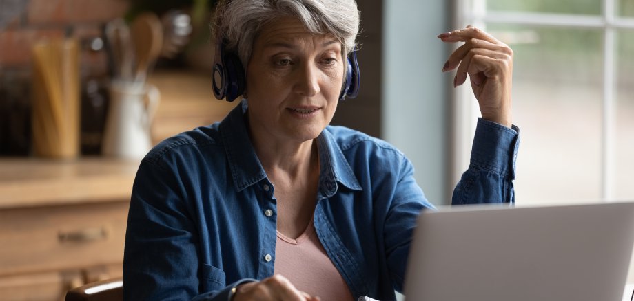 Focused middle aged mature woman studying distantly.