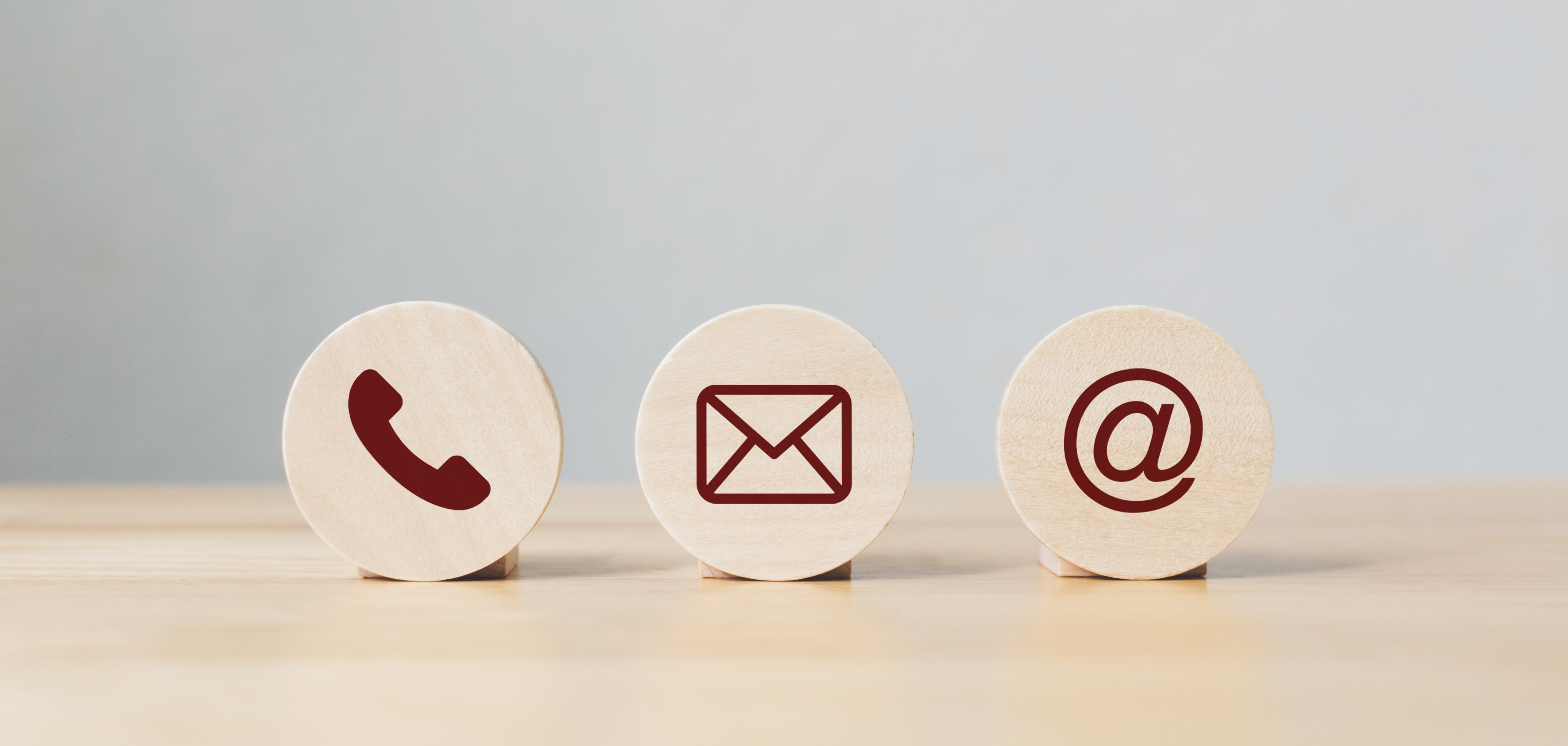 Wooden coins with symbol telephone, email, address. Website page contact us or e-mail marketing concept Wooden coins with symbol telephone, email, address. Website page contact us or e-mail marketing concept