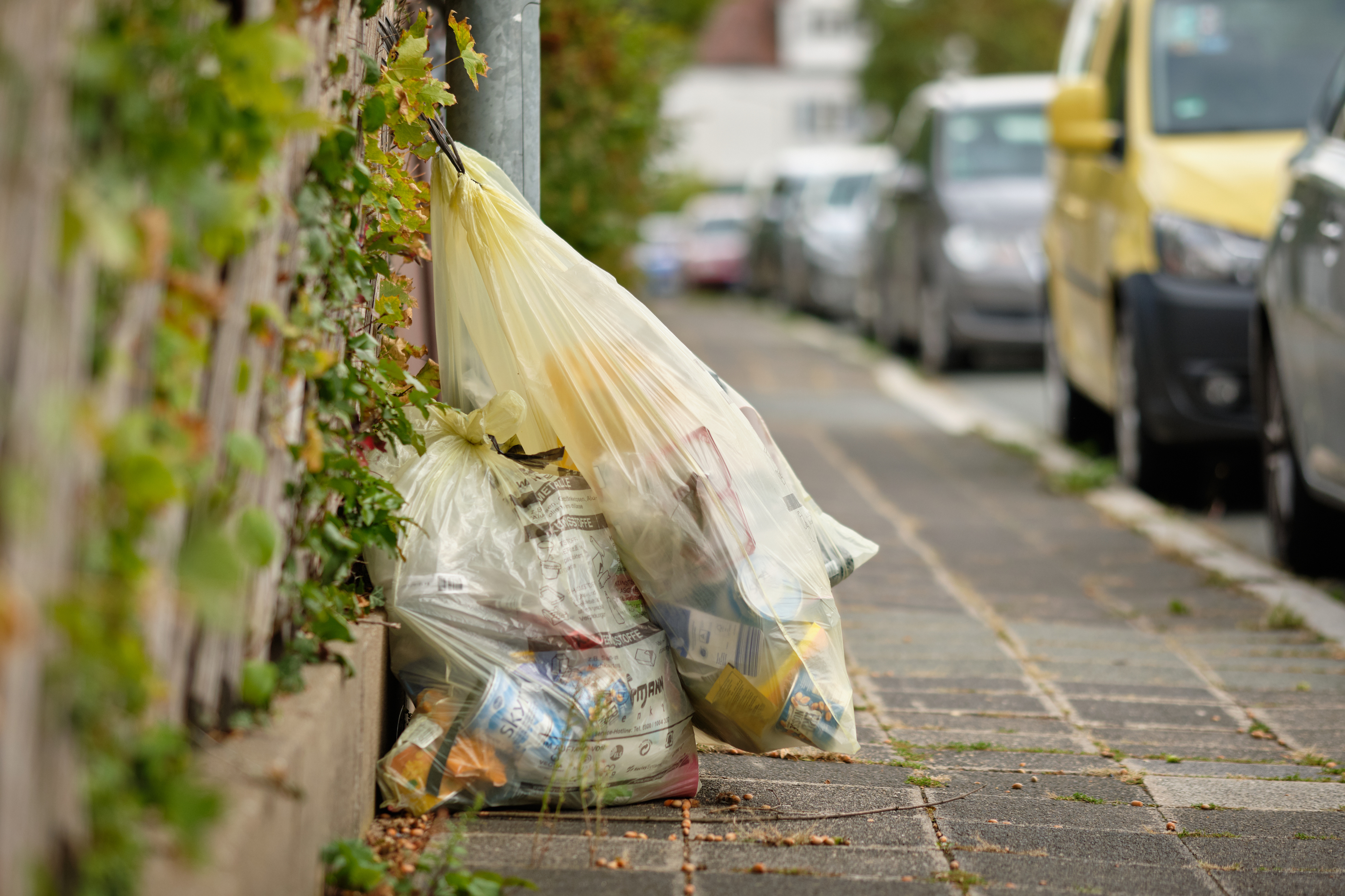 Yellow plastic garbage bags called "Gelber Sack" in residential area Yellow plastic garbage bags called "Gelber Sack" in residential area