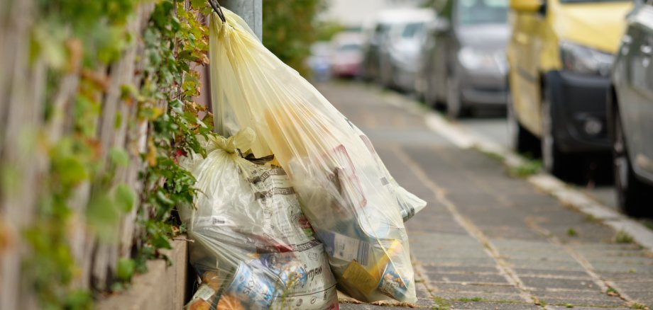 Yellow plastic garbage bags called "Gelber Sack" in residential area