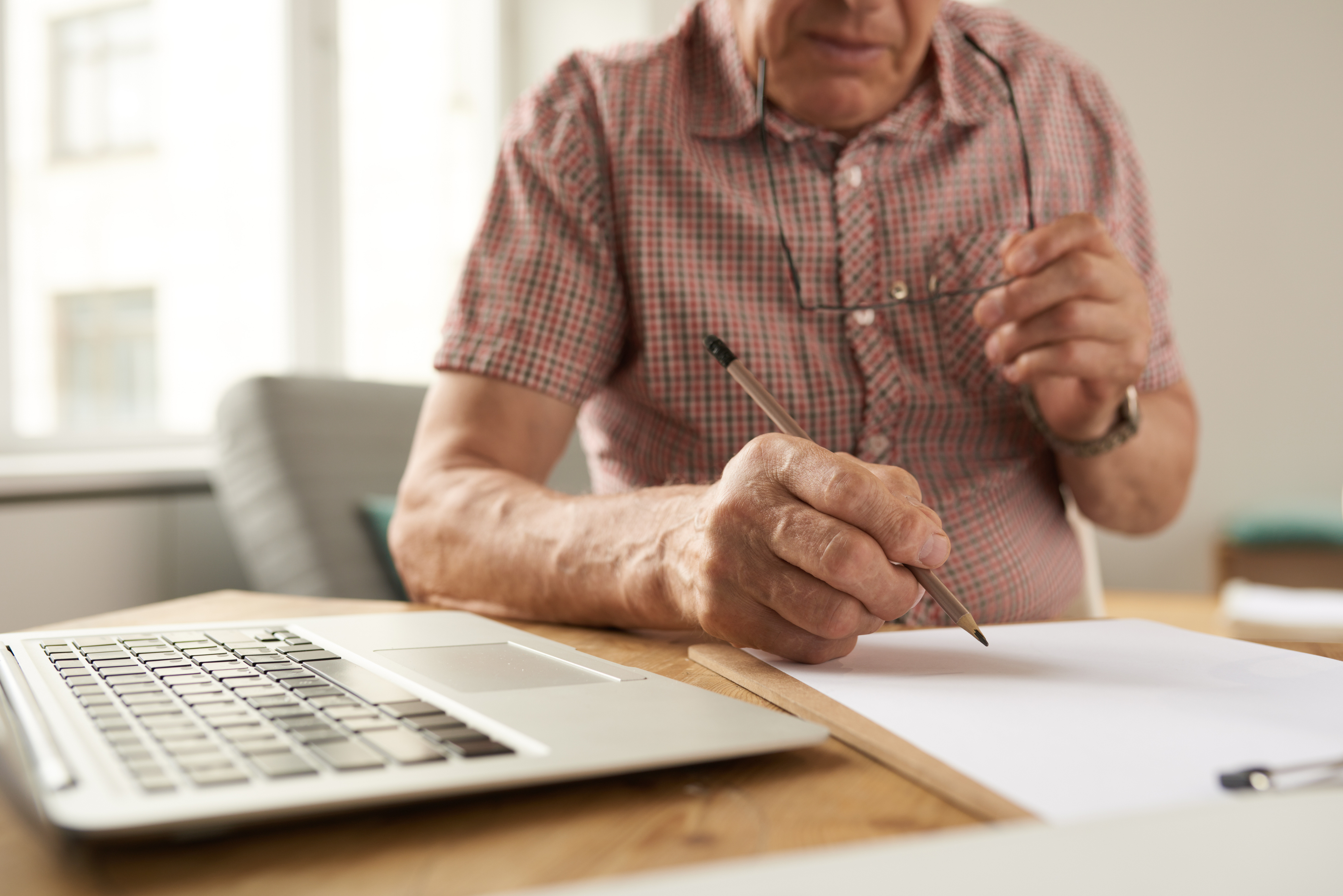 Senior Man Filling Forms at Home Senior Man Filling Forms at Home