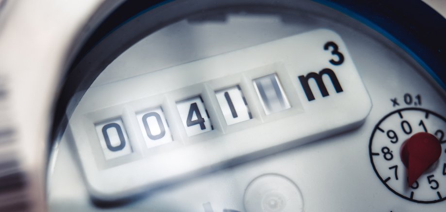 Close up of water meter with rotating digit.