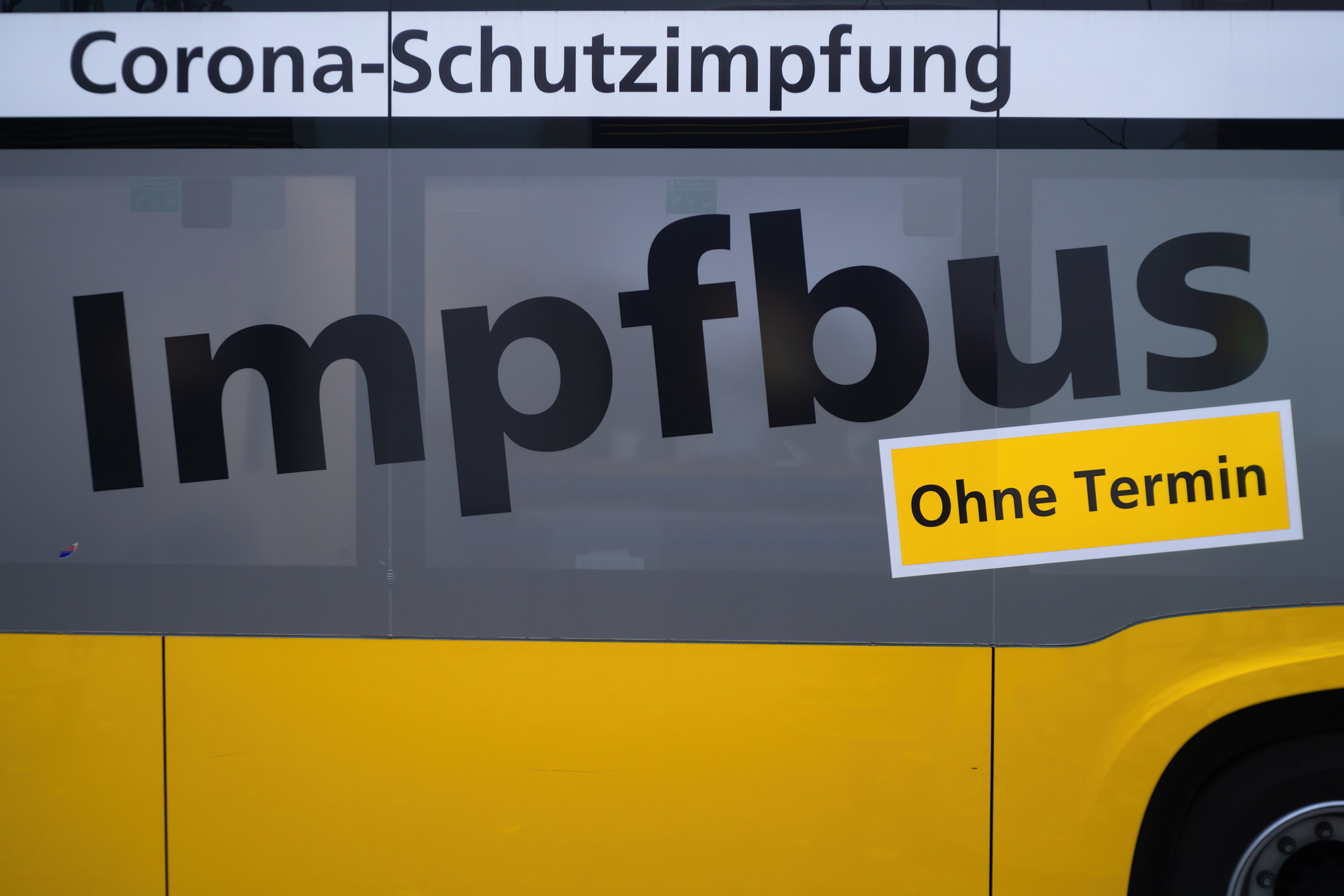 In a yellow vaccination bus medical staff gave people the vaccinations In a yellow vaccination bus medical staff gave people the vaccinations