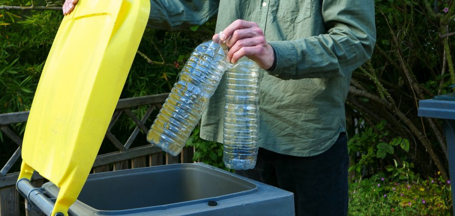 One person making a selective sorting of waste.