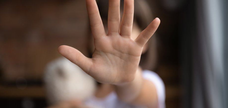 Close up of small girl show ho hand gesture