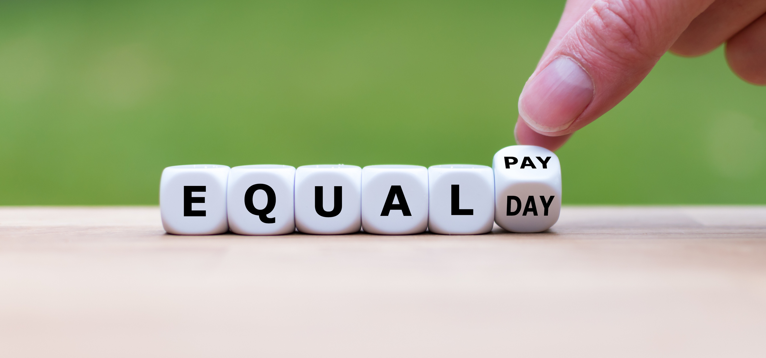 Symbol for the equal pay day. Dice form the expression "EQUAL PAY DAY". Symbol for the equal pay day. Dice form the expression "EQUAL PAY DAY".