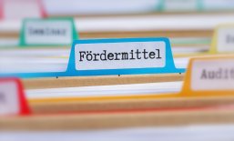 File folders with a tab labeled Funding in german - Fördermittel File folders with a tab labeled Funding in german - Fördermittel