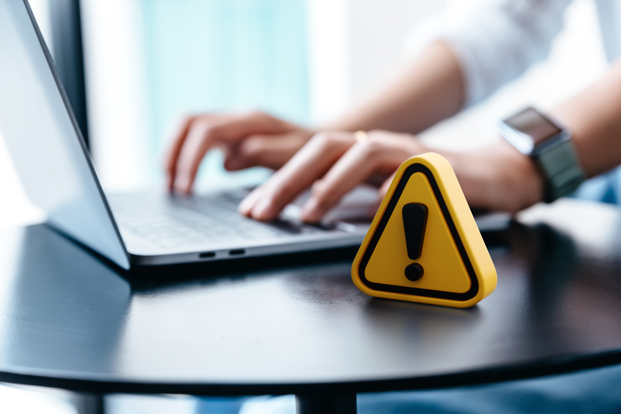 Warning sign placed on a table while businesswoman work. Warning sign placed on a table while businesswoman work.