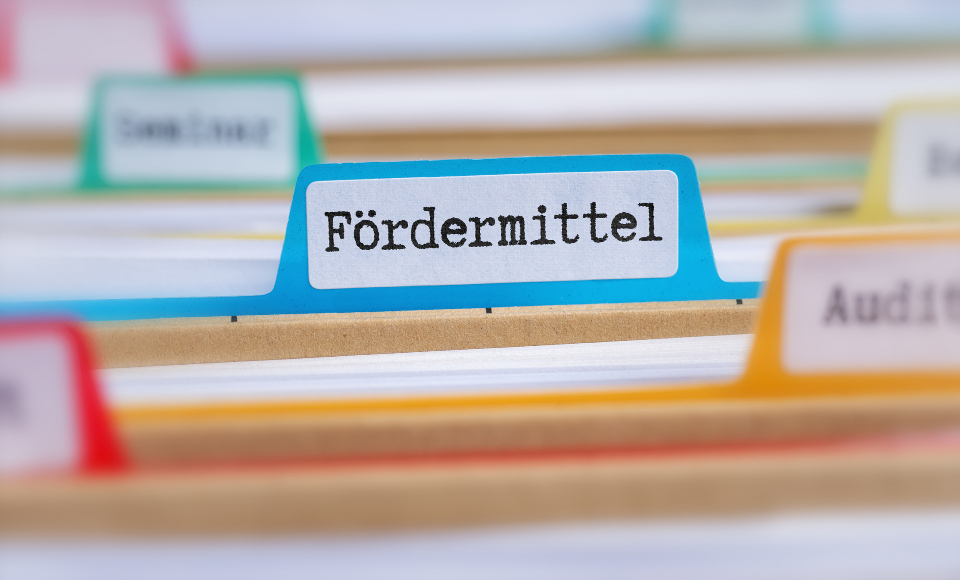 File folders with a tab labeled Funding in german - Fördermittel File folders with a tab labeled Funding in german - Fördermittel