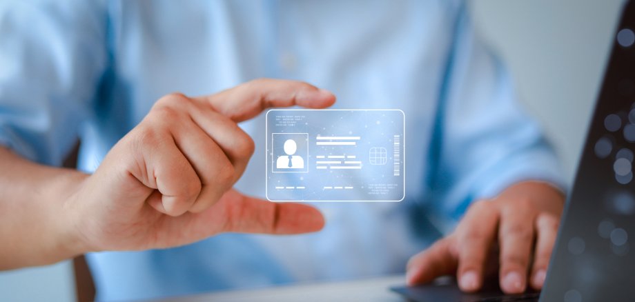 Close-up of man holding ID card. Technology and innovation concept. Digital ID card.