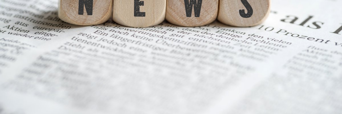 cubes with the word "news" on a newspaper cubes with the word "news" on a newspaper
