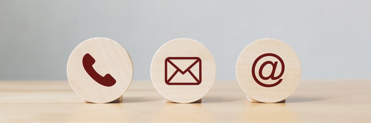 Wooden coins with symbol telephone, email, address. Website page contact us or e-mail marketing concept