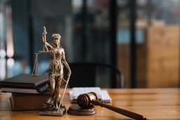 Statue of lady justice on desk of a judge or lawyer. Statue of lady justice on desk of a judge or lawyer.