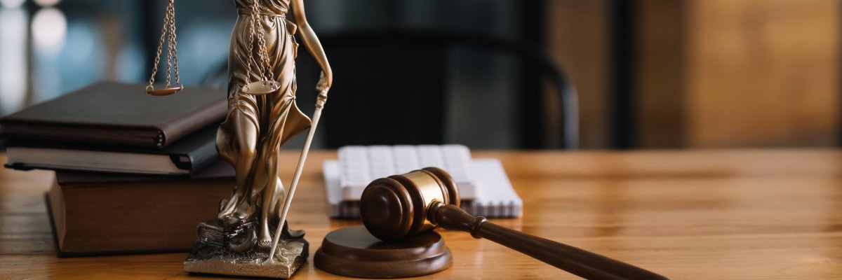 Statue of lady justice on desk of a judge or lawyer. Statue of lady justice on desk of a judge or lawyer.