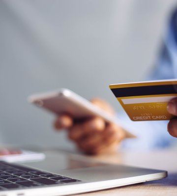 Online payment hands holding credit card and using laptop. Online shopping concept.