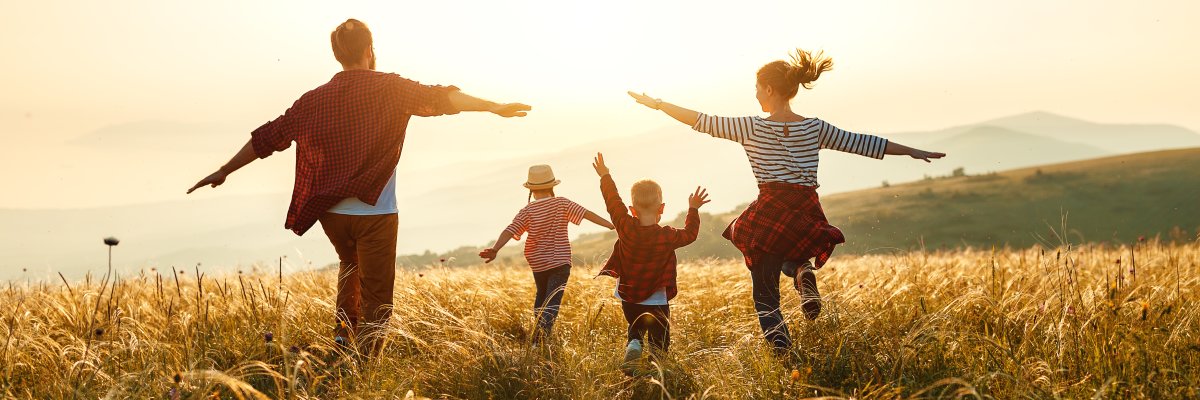 Happy family: mother, father, children son and daughter on sunset
