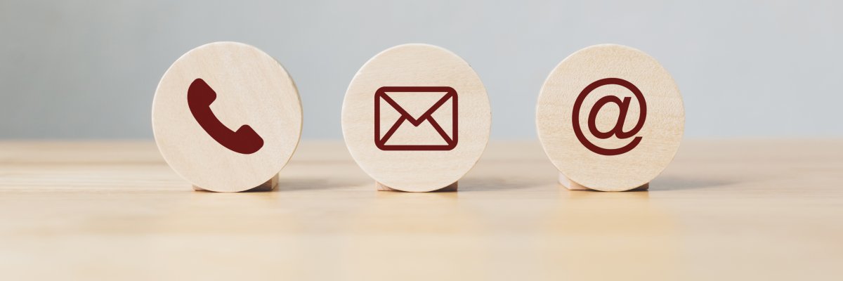 Wooden coins with symbol telephone, email, address. Website page contact us or e-mail marketing concept