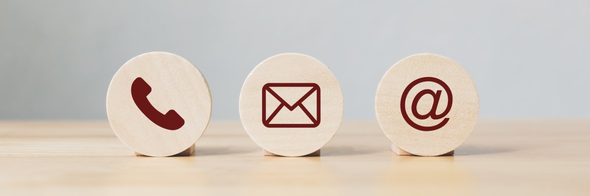 Wooden coins with symbol telephone, email, address. Website page contact us or e-mail marketing concept