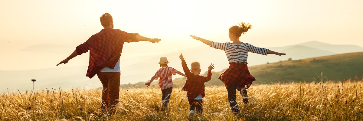 Happy family: mother, father, children son and daughter on sunset
