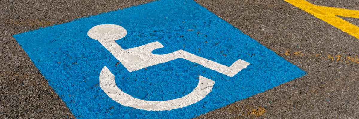 disabled blue parking sign painted on dark asphalt in Canada disabled blue parking sign painted on dark asphalt in Canada