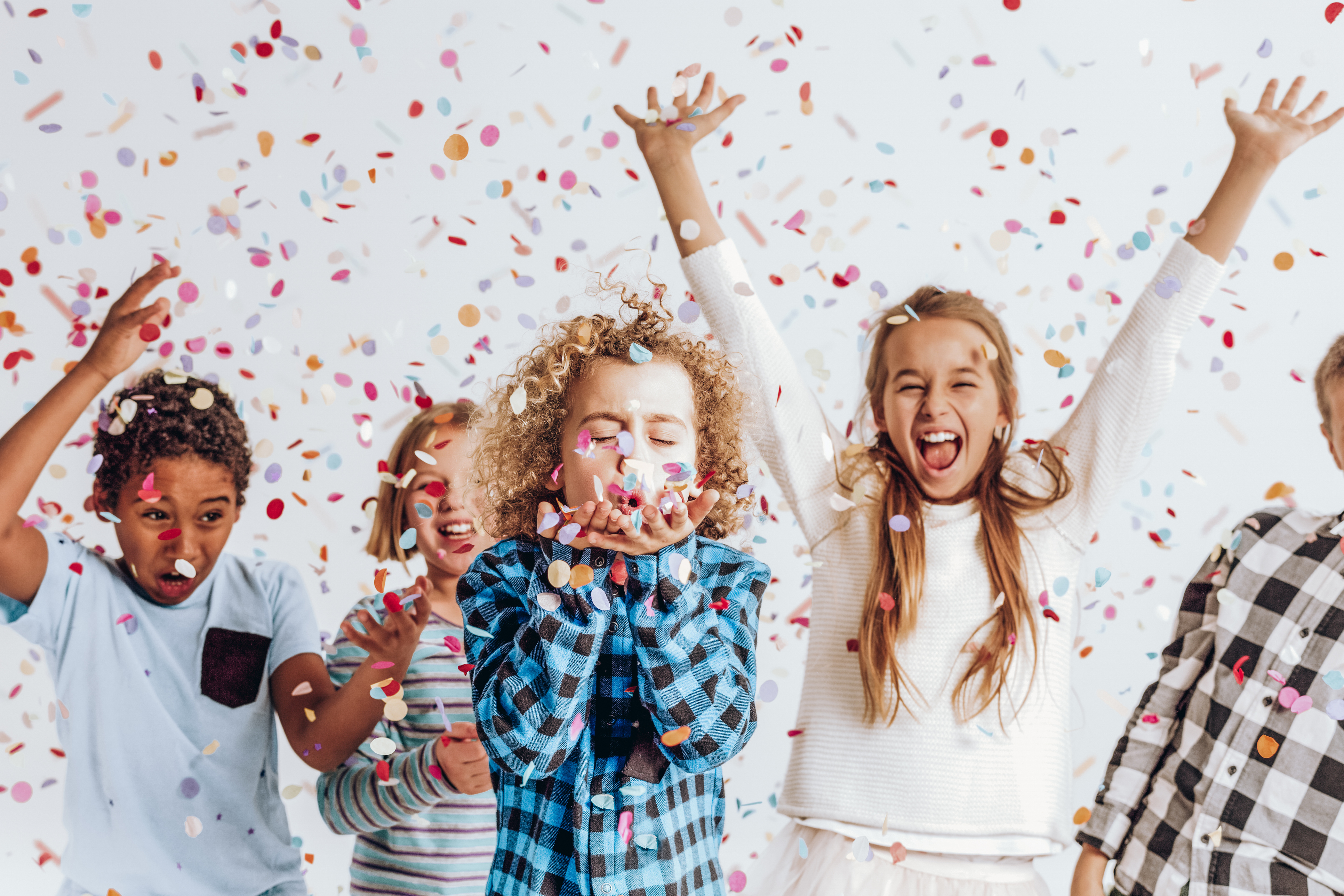 Kids in a room full of confetti Kids in a room full of confetti