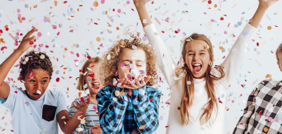 Kids in a room full of confetti