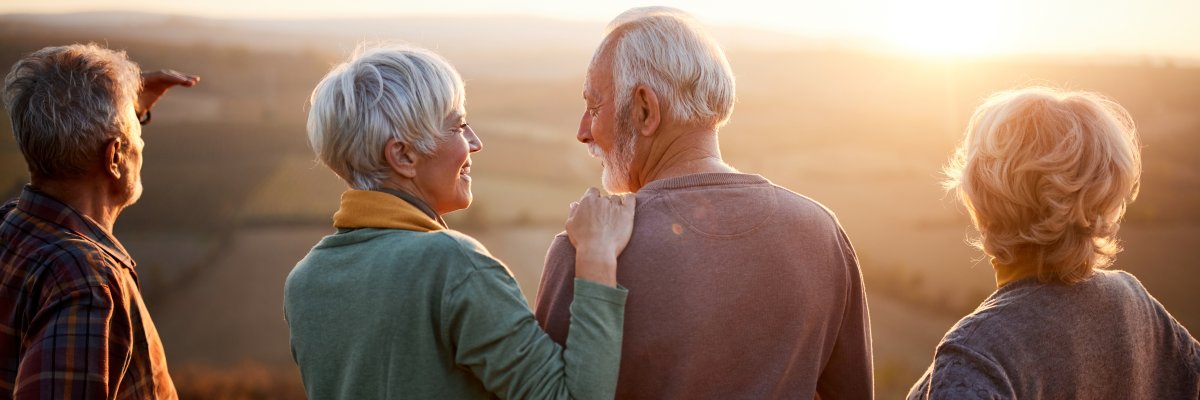 Happy mature friends on a hill in autumn day at sunset. Happy mature friends on a hill in autumn day at sunset.